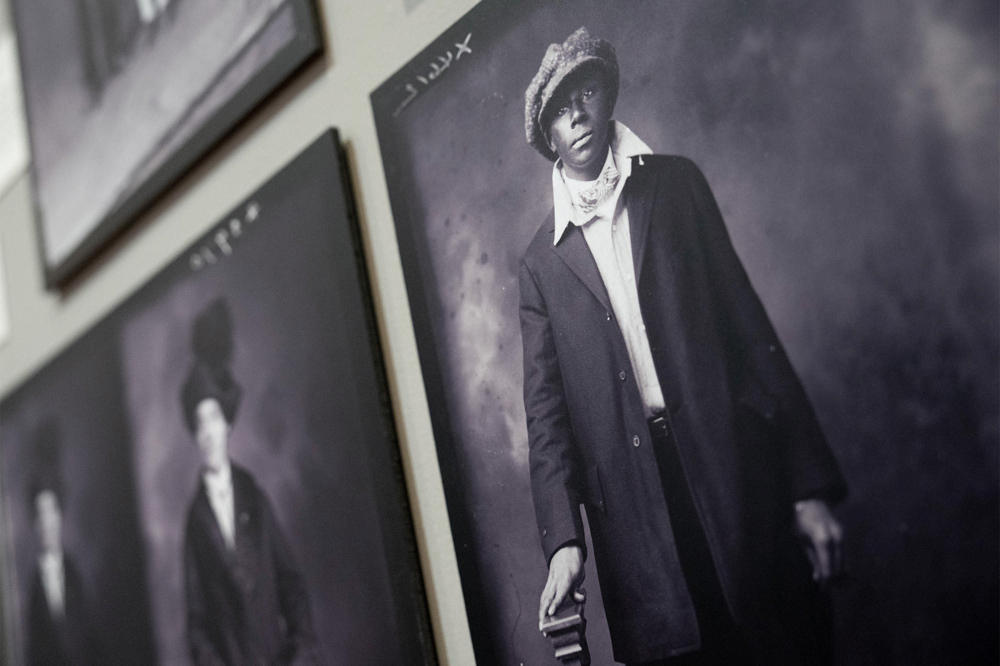 A photo of a portrait of a Black man wearing a cap. 
