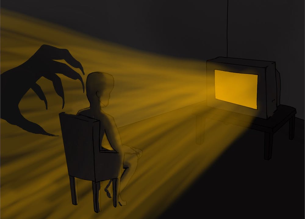 A scary image of a hand reaching for someone on a chair