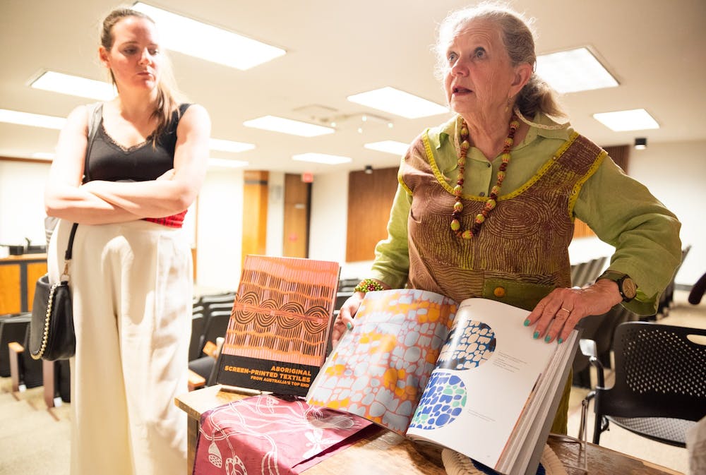 An image of a woman presenting from a book