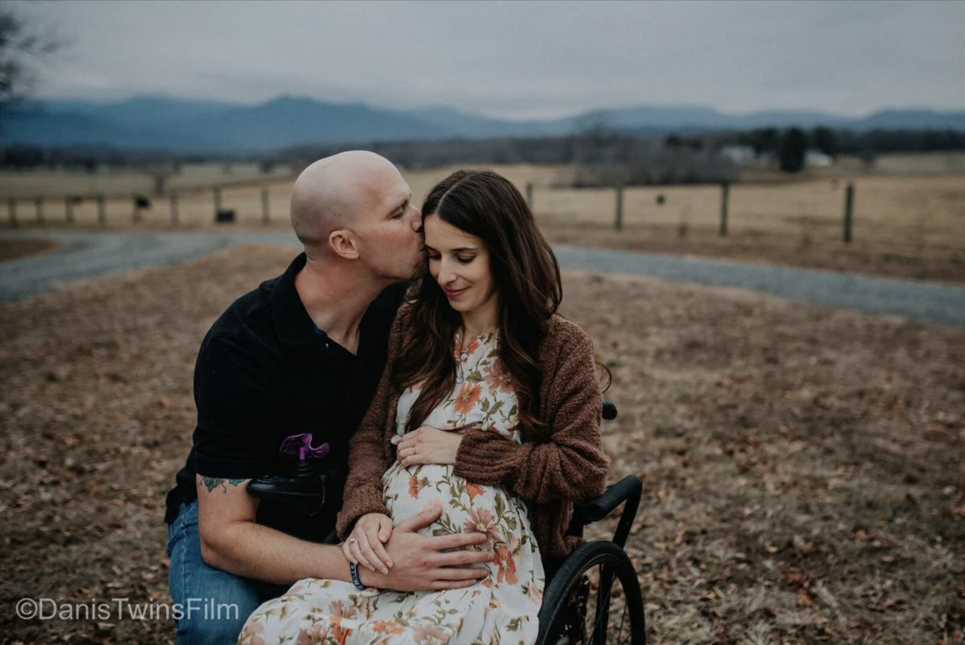 An image of a pregnant woman in a wheelchair with her husband