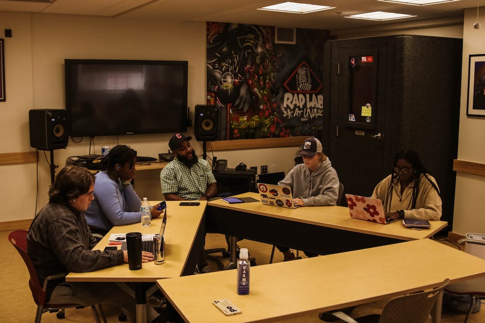 An image of AD Carson and students around a table