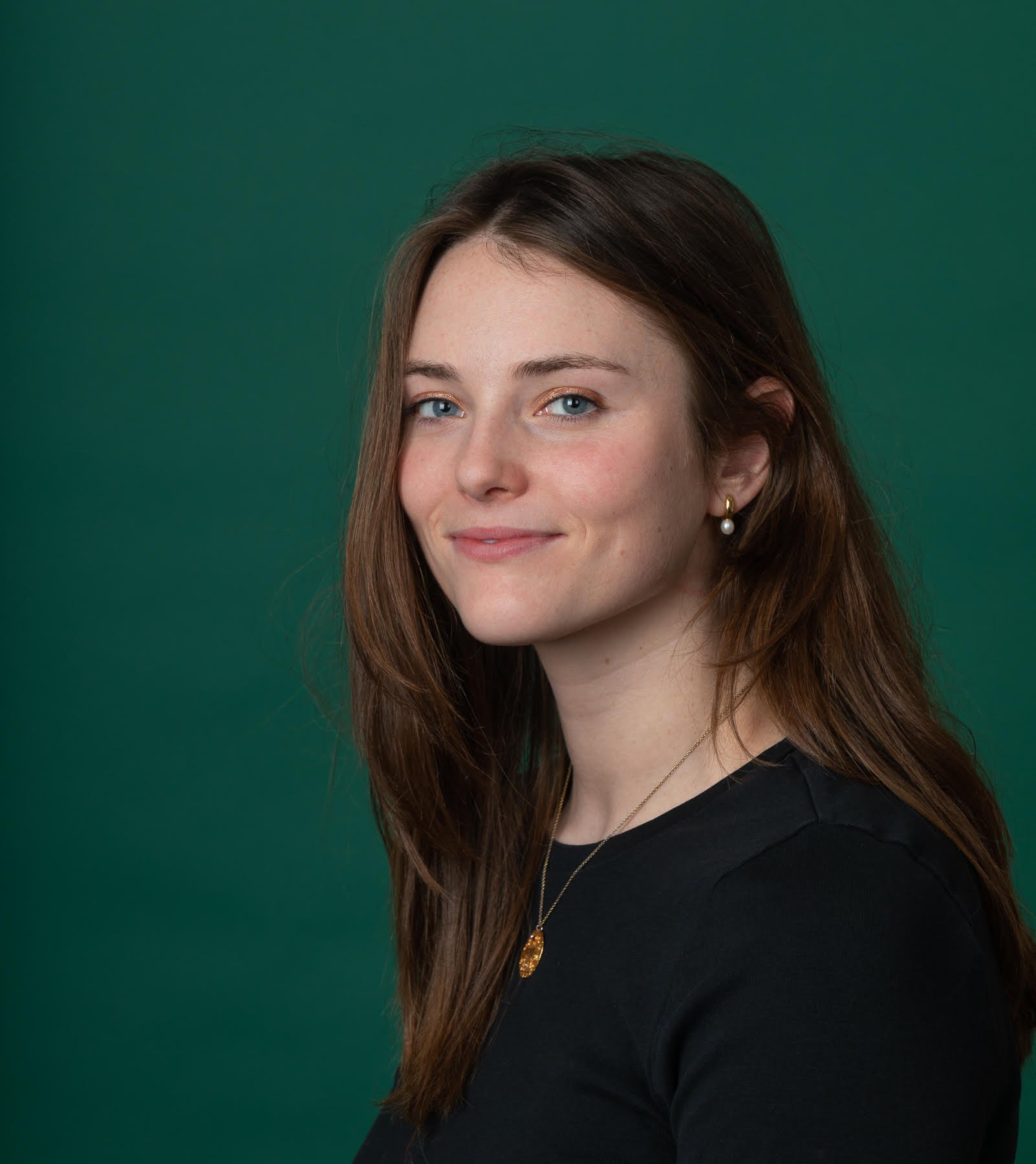 Margaret Saunders stands against a green background