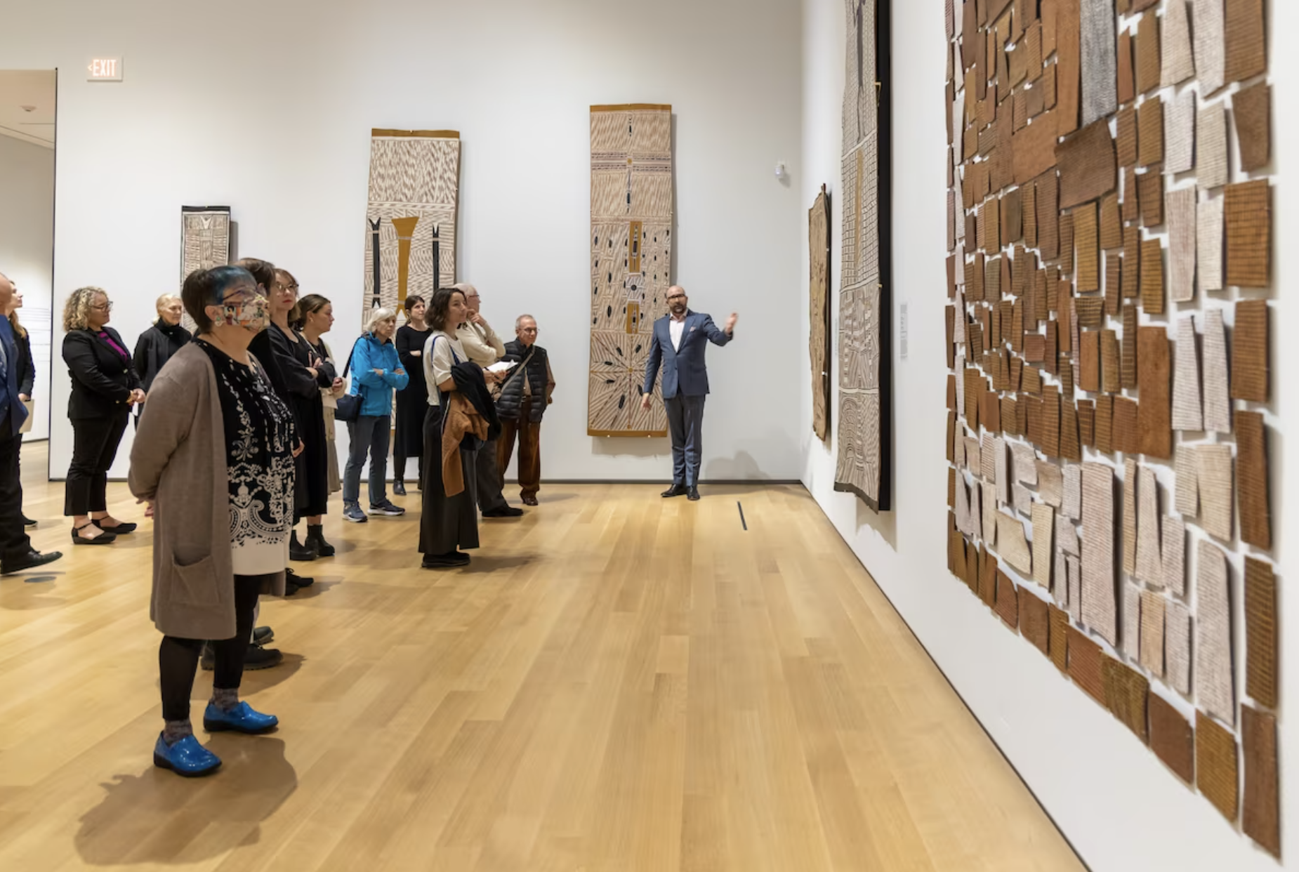 An image of people looking at art in a gallery