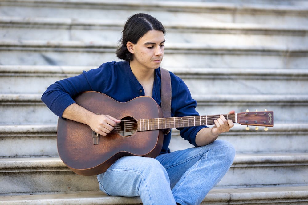 An image of Luke Powers with his guitar
