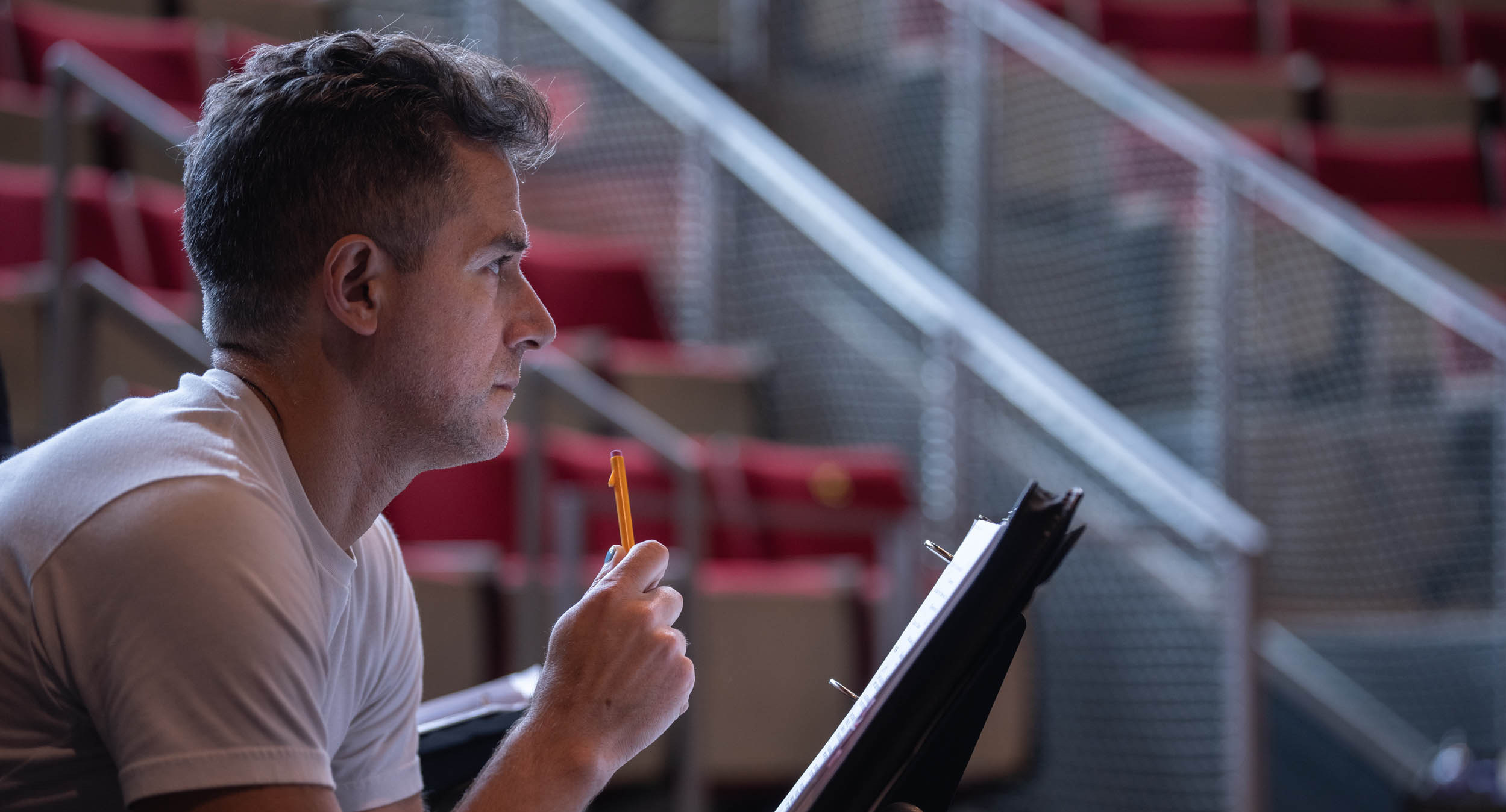 Profile view of director Matthew Steffens in the Caplin Theatre.