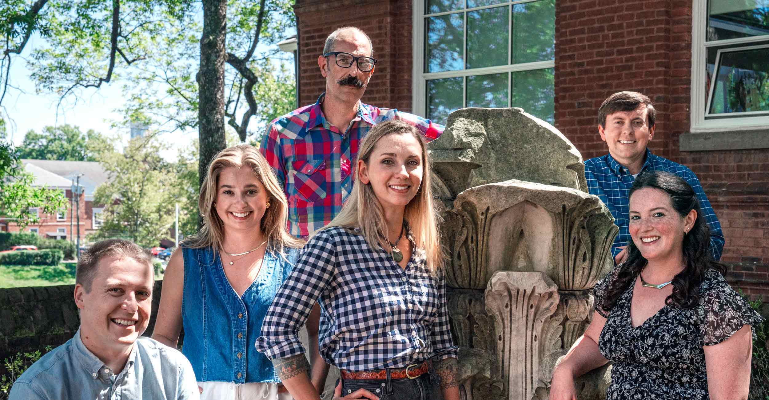 The UVA Obscura team poses around a discarded portion of one of the Rotunda's columns