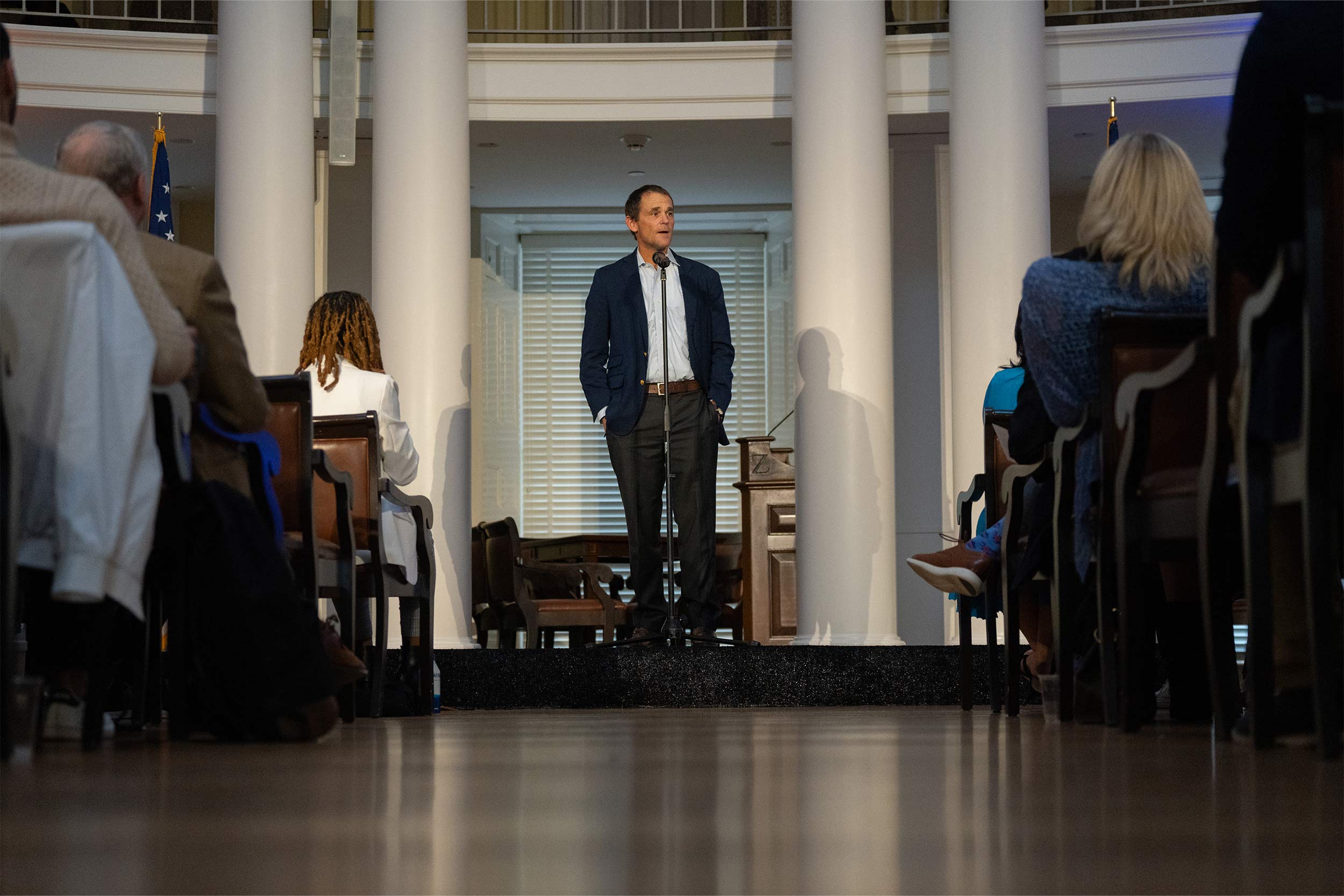 UVA President Jim Ryan stands while giving a speech in the rotunda with his hands in his pockets.