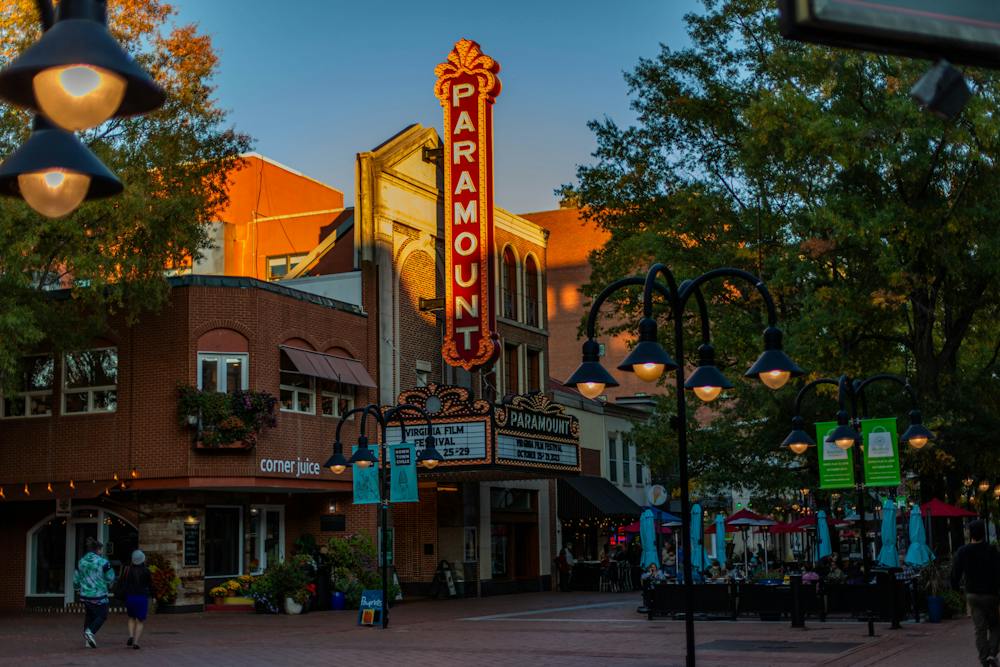 The sun sets on the Paramount Theater, a 1930s-style theater with a light-up marquee.