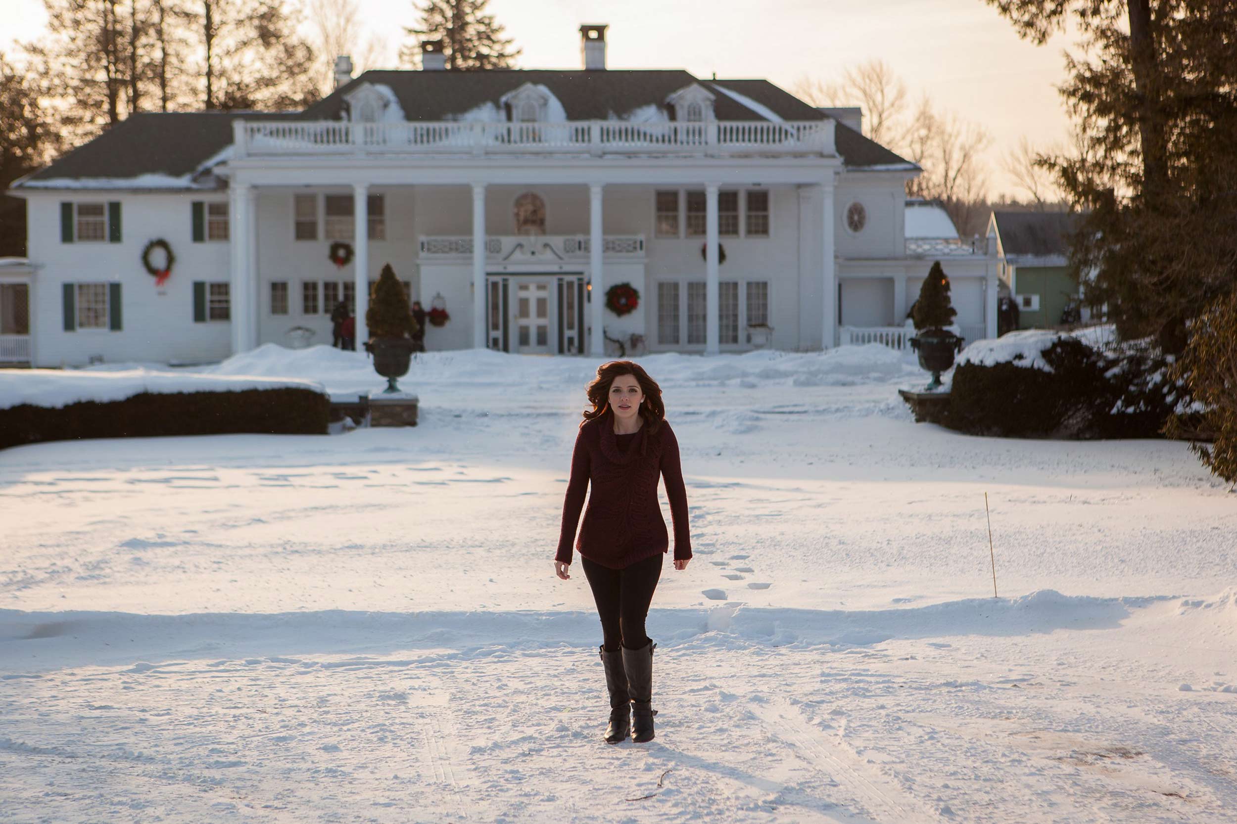 Jen Lilley, a woman wearing all black, stands in the snow 