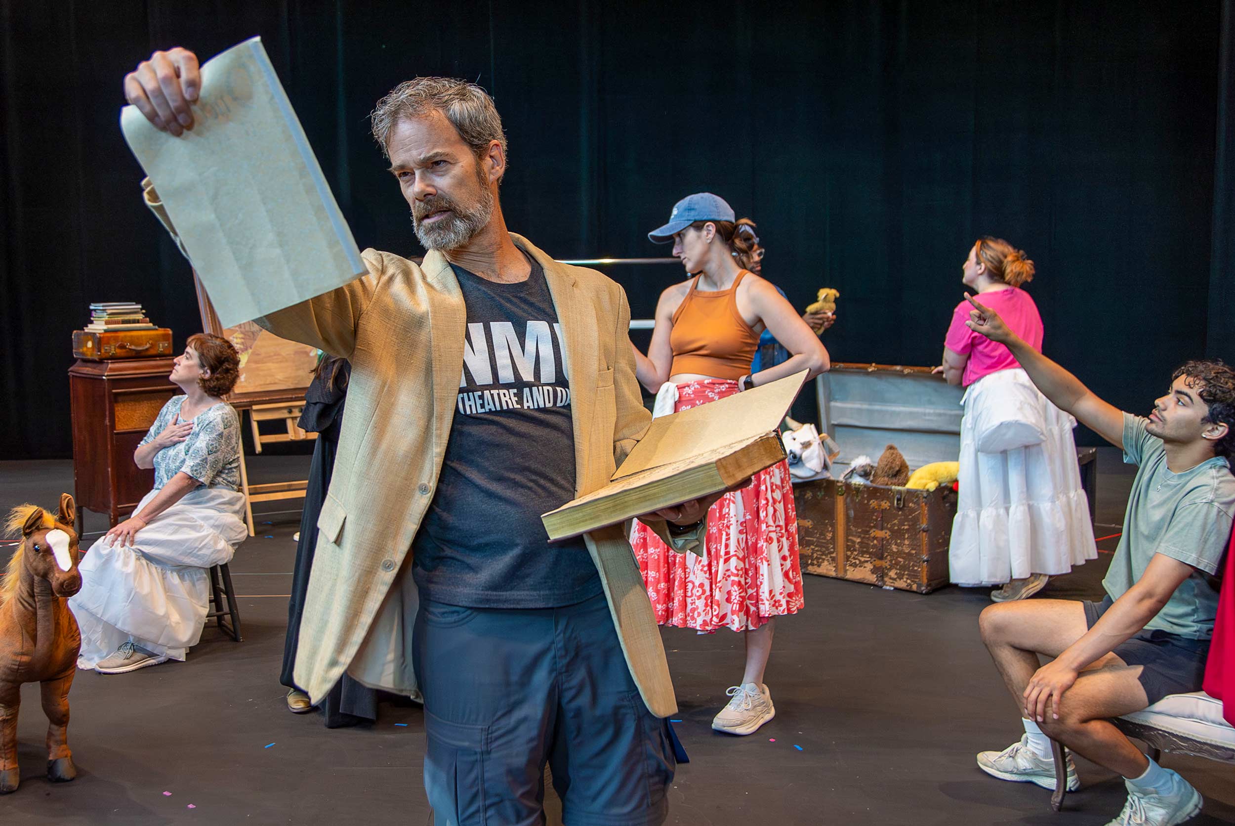 The cast of Into the Woods rehearses in costume and with props.