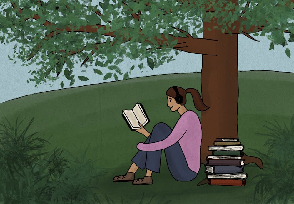 A digital drawing of a girl sitting under a tree reading a book with headphones on. A stack of more books sits next to her, and she is on a green hill.