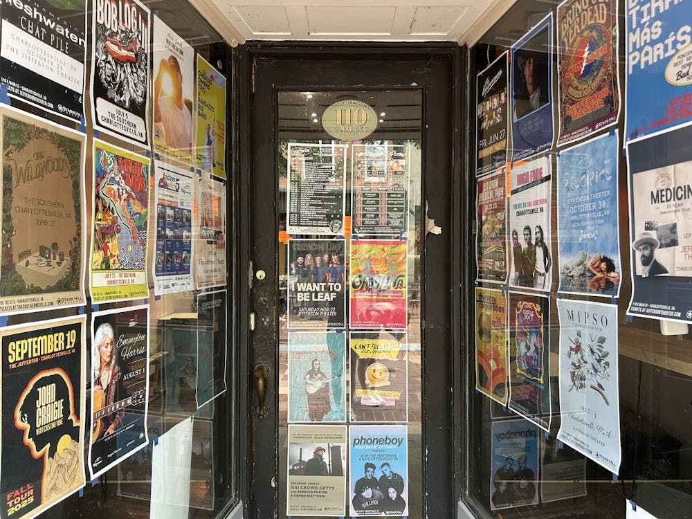 A small hallway and a store entrance are covered with posters advertising arts events.