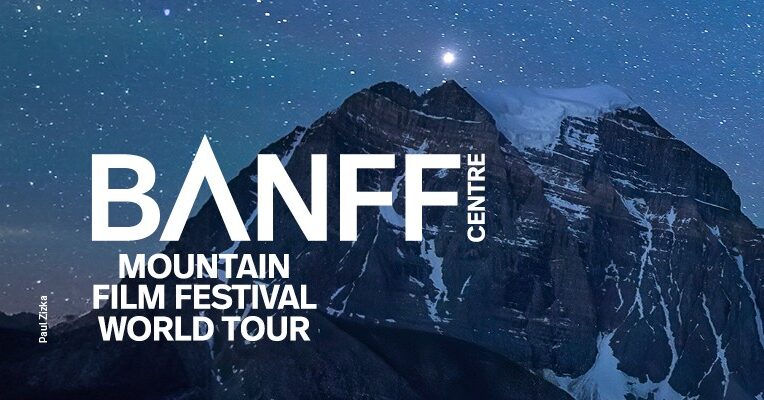 A photo of a mountain in front of a blue starry night sky. The moon is shown near the tip of the mountain. In white letters, "BANFF Centre Mountain Film Festival World Tour" is titled to the left side of the image.