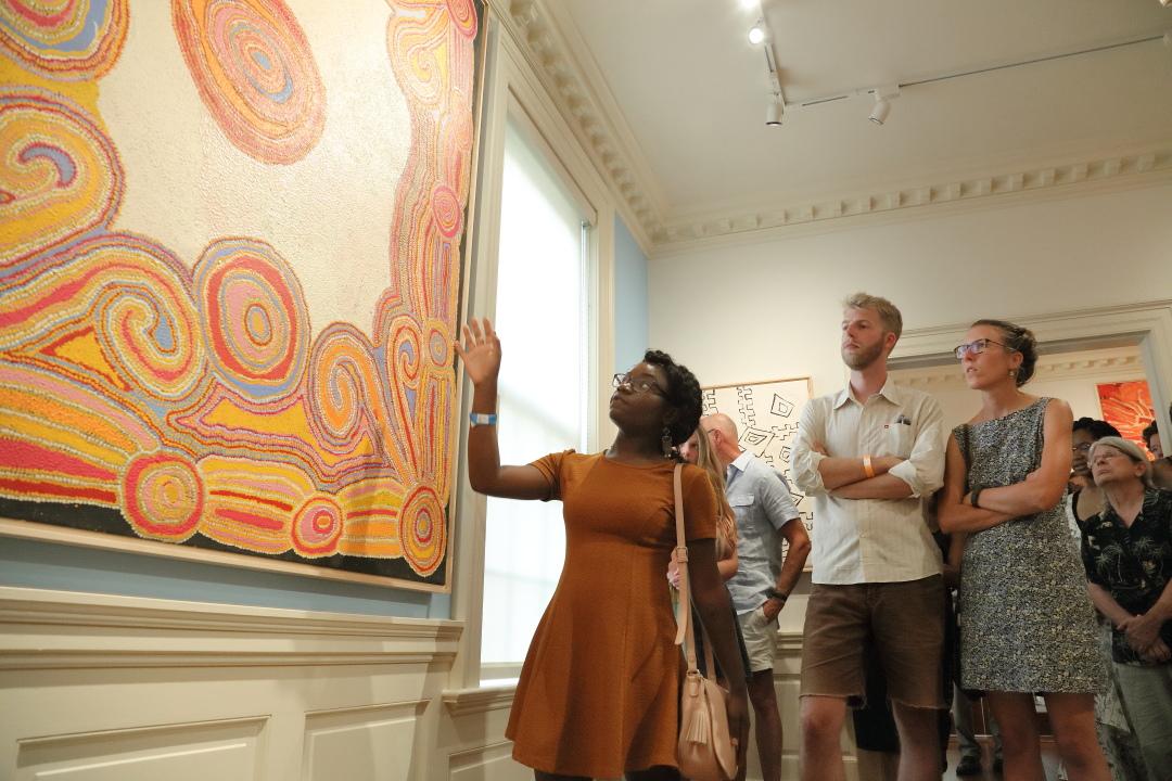 Students looking at a painting in a museum 